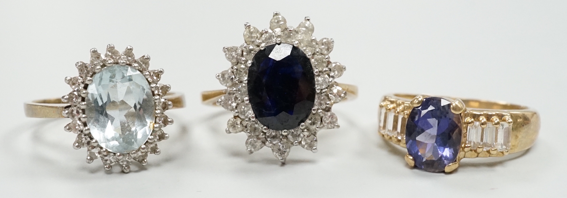 Three assorted modern 9ct gold and gem set dress rings, including sapphire and diamond chip set oval cluster, size K/L, gross weight 9.6 grams.